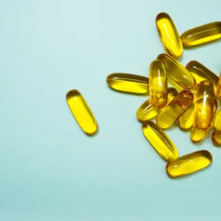 Yellow capsules scattered on a light blue background.