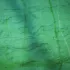 Green textured surface with wavy patterns and vertical lines.