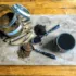 Jar of chaga powder, two spoons with powder, and a cup on a wooden board.