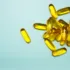 Yellow capsules scattered on a light blue background.