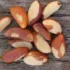 Brazil nuts scattered on a wooden surface.