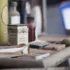 Vintage aspirin box on a dusty shelf with various bottles and packages in the background.