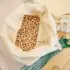 Open cloth bag filled with chickpeas on a wooden table.