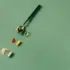 Spoon with oil, capsules, and powders on a green background.