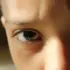 Close-up of a person's eyes and forehead in natural light.