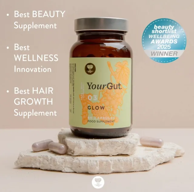 YourGut Glow supplement bottle on stone, awarded Best Beauty, Wellness, Hair Growth Supplement.