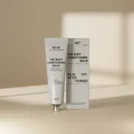 Tube and box of AKT SC.02 Body Conditioning Balm on beige background.