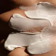 White cream applied on skin in smooth, thick layers.