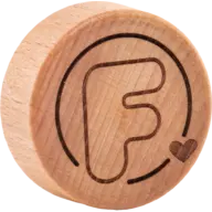 Round wooden lid with engraved letter "F" and heart symbol.