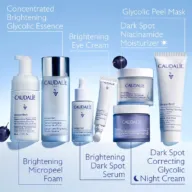 Caudalie Vinoperfect skincare range with labelled products on a blue background.