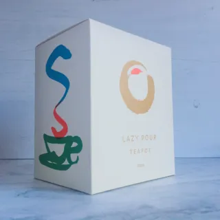 Box with "Lazy Pour Teapot 500ml" text and colourful cup design.