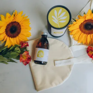 Sunflowers, a bottle, and a candle with leaf logo on a cloth bag labelled "Castorvida".