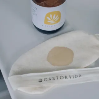 Castorvida bottle and cloth with logo on a white surface.