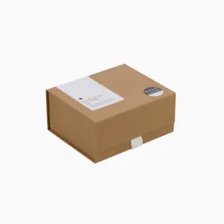 Brown cardboard gift box with white label and round black sticker.