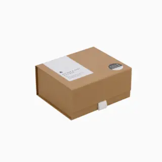 Brown cardboard gift box with white label and round sticker.