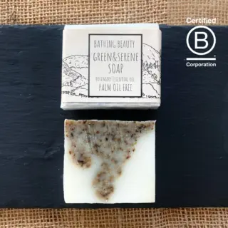 Soap bar and packaging on slate. Text: Bathing Beauty Green & Serene, palm oil free.