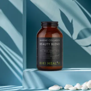 Brown jar of Kiki Health Marine Collagen Beauty Blend on a blue shelf.