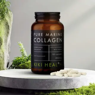 Brown bottle of Pure Marine Collagen capsules on a stone surface with greenery.