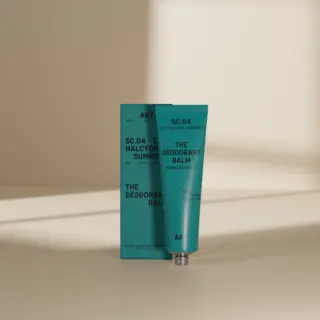 Teal deodorant balm tube and box with text "SC.04 Halcyon Summers".
