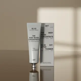 SC.02 Body Wash Concentrate tube and box on a reflective surface. Cedar, eucalyptus, orange scent.
