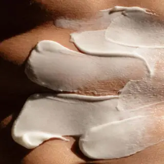 White cream applied on skin in smooth, thick layers.