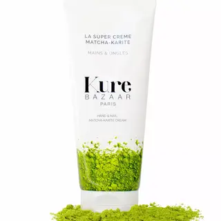 Kure Bazaar Matcha-Karite hand and nail cream tube with green powder.