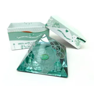 Green glass pyramid with geometric design, open box with text "Breathing new life into every room".
