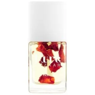 Clear nail polish bottle with red flower petals inside. White cap.