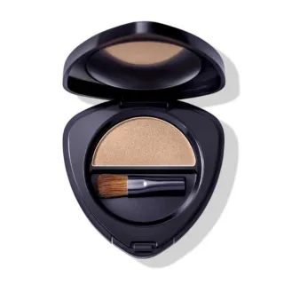 Open compact with beige powder and small brush inside.