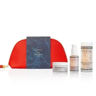 Red pouch with Oskia skincare products: Renaissance Mask, Body Treatment, and Moon Salts.