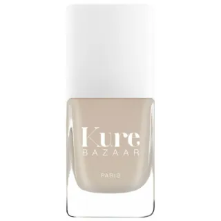 Kure Bazaar Paris nail polish in a beige shade with a white cap.