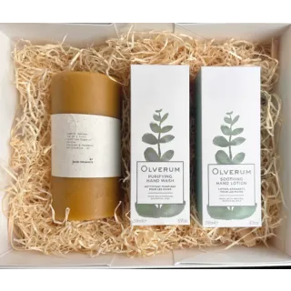 Gift box with candle, Olverum hand wash and lotion on straw bedding.