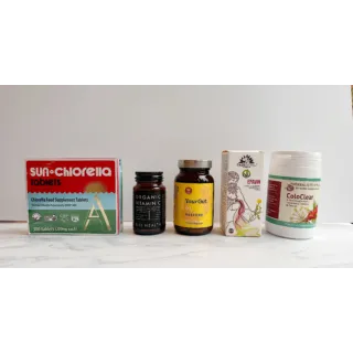 Five supplement bottles and boxes on a white surface, including Sun Chlorella and ColoClear.