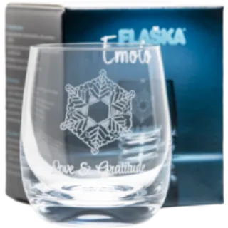 Glass with snowflake design, text "Emoto" and "Love & Gratitude", blue box in background.
