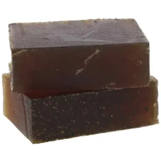 Two stacked bars of dark brown soap with a textured surface.