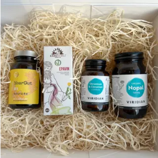 Four supplement bottles on straw bedding: YourGut, Epavin, Chromium & Cinnamon, Organic Nopal.