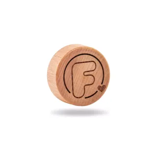 Wooden disc with engraved letter "F" and heart symbol.