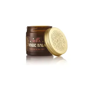 Brown jar of MOA Magic Balm, yarrow and tea tree, with a gold lid beside it.