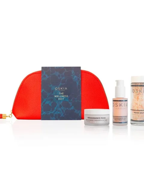 Red pouch with Oskia products: mask, body treatment, moon salts, and a booklet.