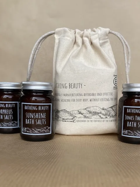 Three jars of Bathing Beauty bath salts with a drawstring bag.