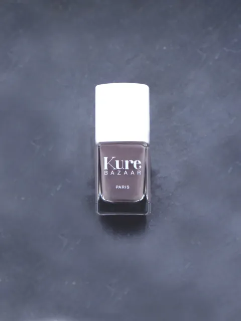 Kure Bazaar nail polish bottle on a dark surface.