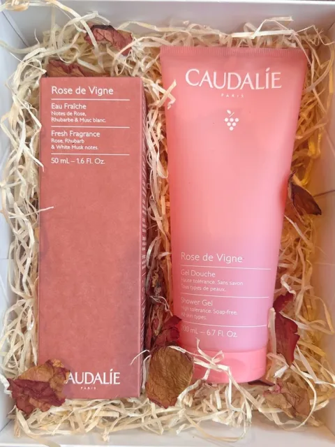 Caudalie Rose de Vigne shower gel and eau fraîche in a gift box with straw and dried petals.