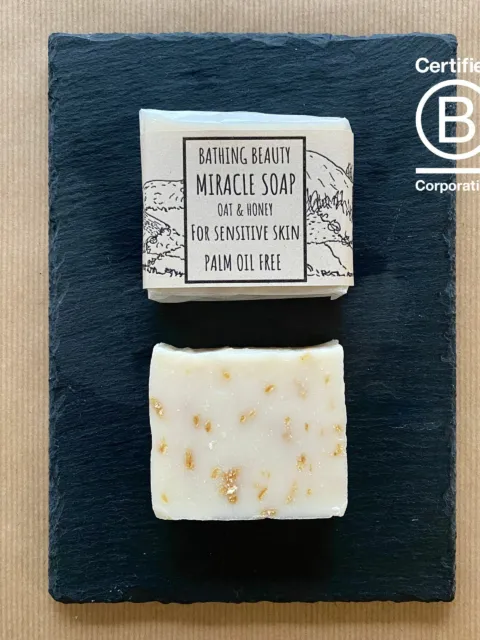 Two bars of oat and honey soap on a slate, labelled for sensitive skin. Certified B Corporation logo.