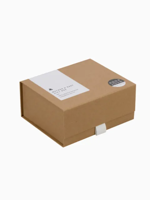 Brown cardboard gift box with white label and round sticker.