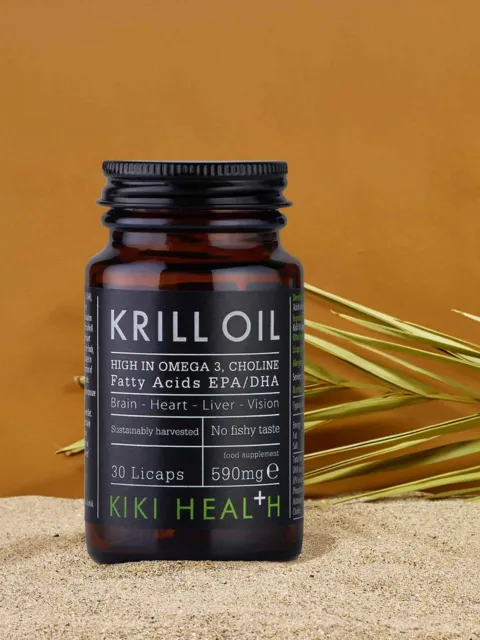Krill Oil supplement bottle on sand with grass, labelled high in Omega 3, choline, 590mg, 30 Licaps.