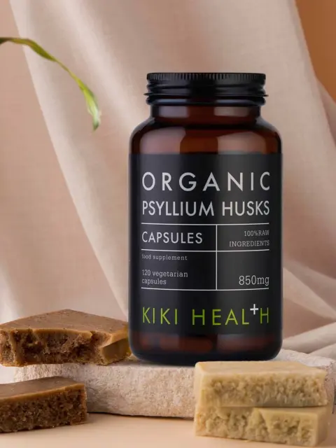 Kiki Health Organic Psyllium Husks capsules, 850mg, with soap bars on a fabric background.