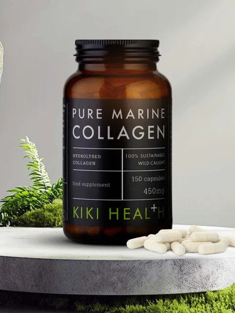 Brown bottle of Pure Marine Collagen capsules on a stone surface with greenery.