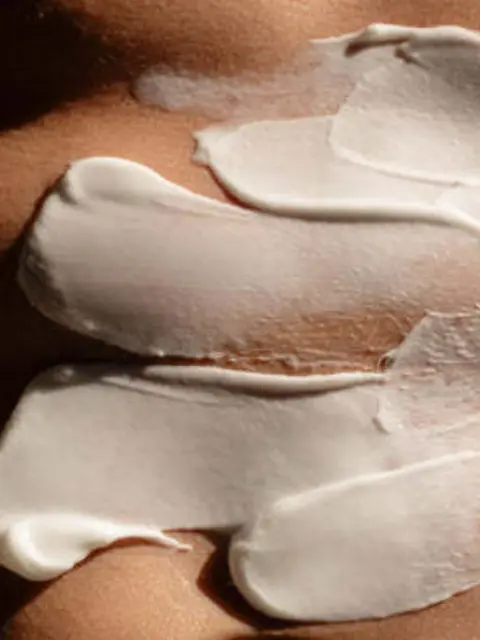 White cream applied on skin in smooth, thick layers.