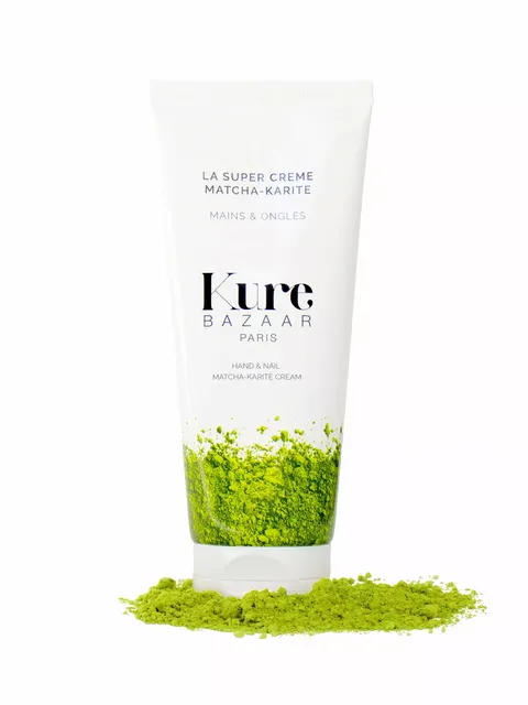 Kure Bazaar Matcha-Karite hand and nail cream tube with green powder.