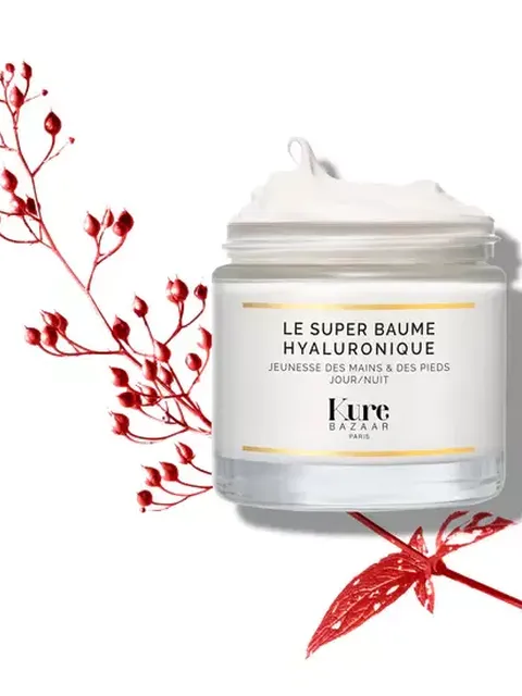 Kure Bazaar Le Super Baume Hyaluronique jar with red botanical accents.